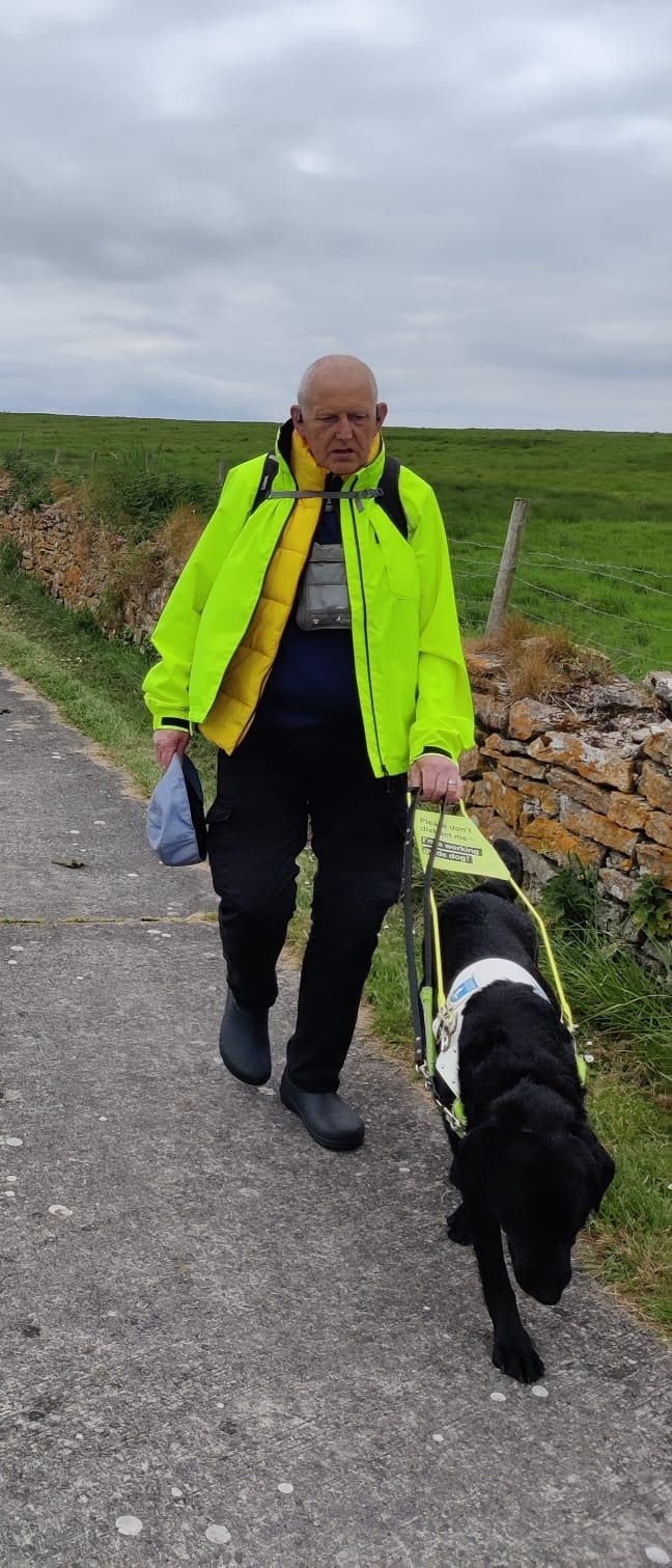 Picture of David Quarmby walking with his guide dog Reg