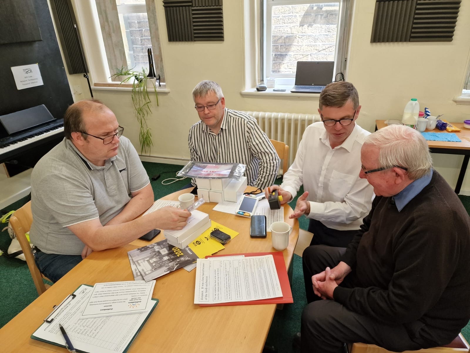 Picture showing Staff member Mark demonstrating tech to group members