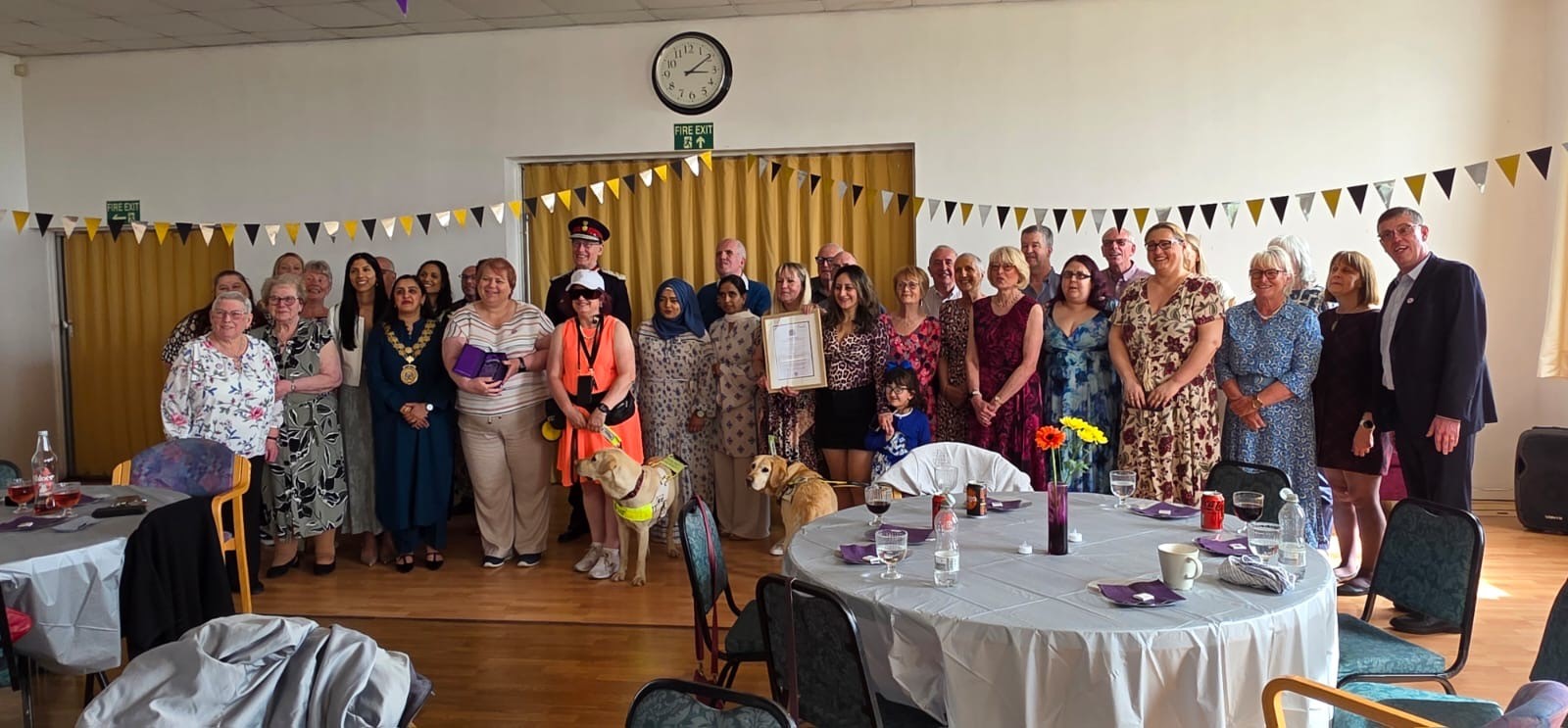 Image shows volunteers and guests at the KAV award celebration event.