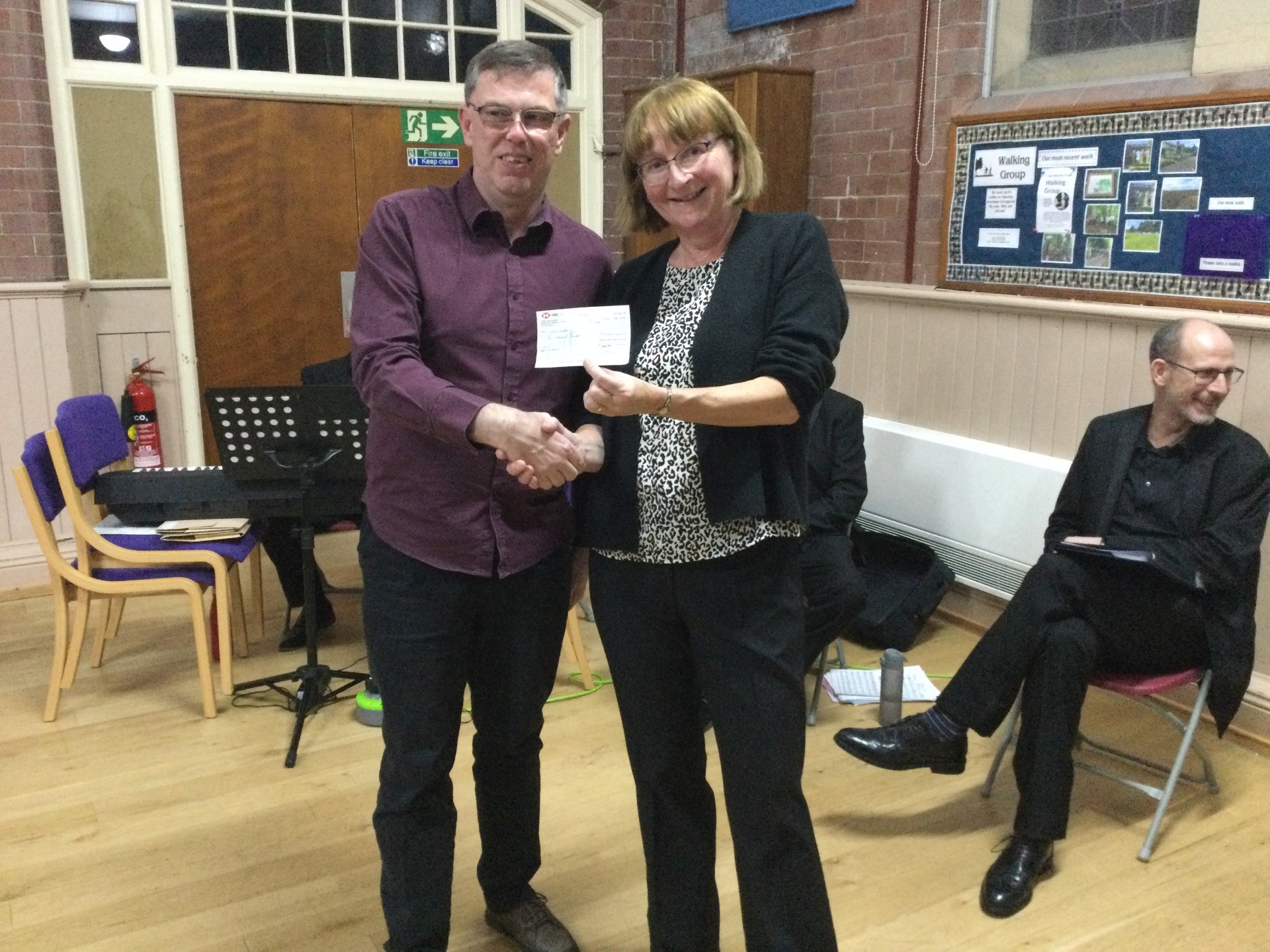 Image of Mark Owen being present with the cheque