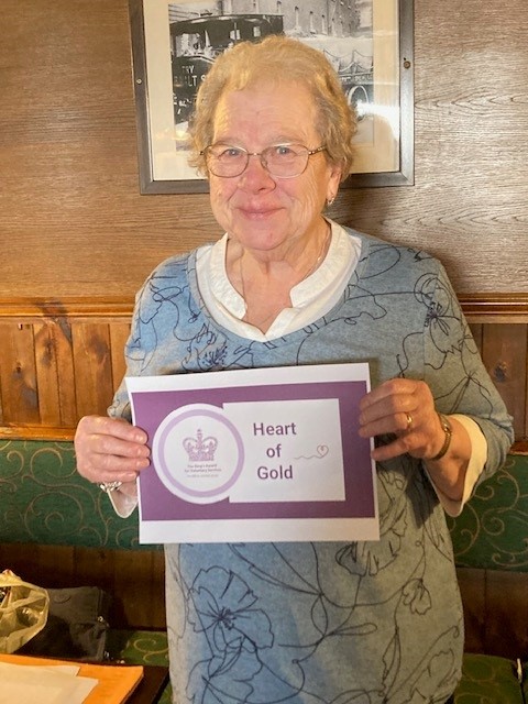 Image of volunteer Jean Tate with her Kings Award certificate