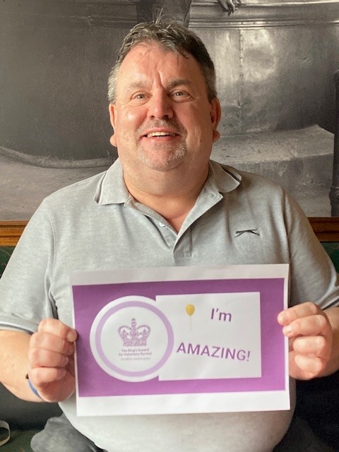 Image of volunteer Martin Eatherley with his Kings Award certificate